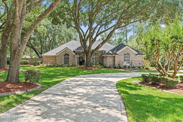595 Glasgow Ct, Orange Park, FL 32073 - view of front facade with brick siding and curved driveway