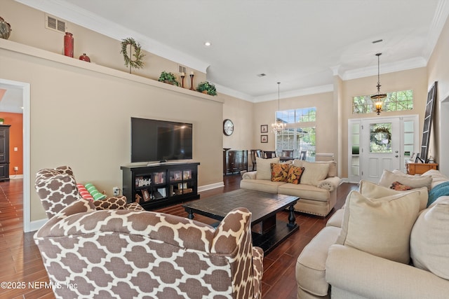 595 Glasgow Ct, Orange Park, FL 32073 - living area with dark wood finished floors, baseboards, recessed lighting, crown molding, and a chandelier