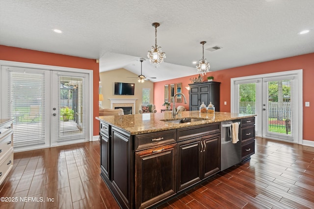 595 Glasgow Ct, Orange Park, FL 32073 - kitchen featuring french doors, a sink, stainless steel dishwasher, a chandelier, and a fireplace