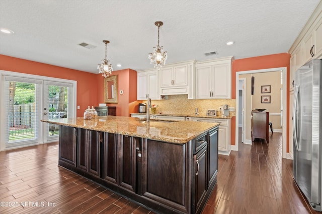 595 Glasgow Ct, Orange Park, FL 32073 - kitchen featuring stainless steel fridge, a chandelier, dark brown cabinets, a sink, and recessed lighting