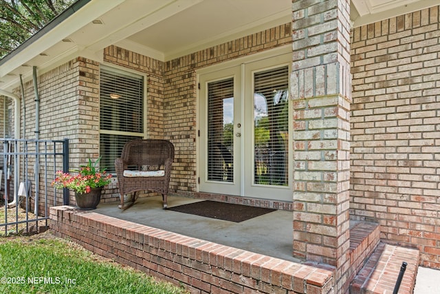 595 Glasgow Ct, Orange Park, FL 32073 - property entrance featuring brick siding, french doors, and covered porch
