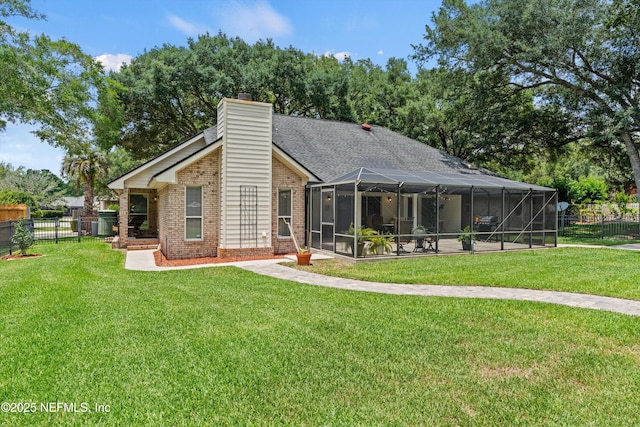 595 Glasgow Ct, Orange Park, FL 32073 - back of property with brick siding, a chimney, and a lanai