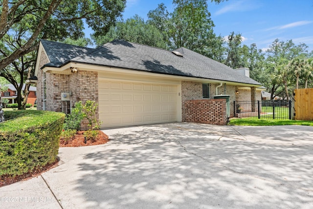 595 Glasgow Ct, Orange Park, FL 32073 - view of front of property with brick siding, a garage, a shingled roof, concrete driveway, and a chimney
