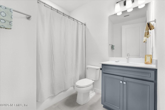 full bathroom featuring toilet, tile patterned flooring, vanity, and shower / tub combo