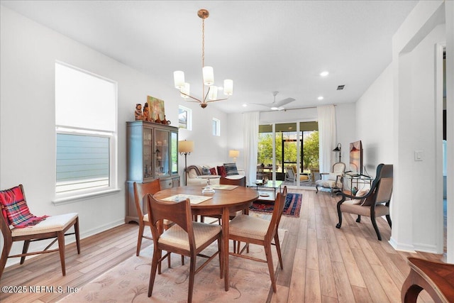 dining area with light wood-type flooring, a chandelier, a ceiling fan, recessed lighting, and baseboards