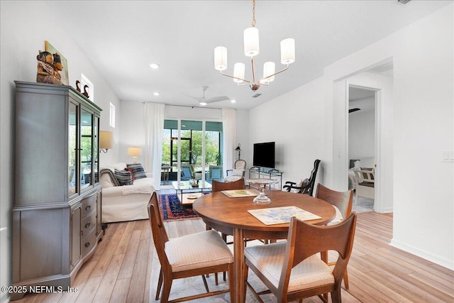 dining room featuring light wood finished floors, ceiling fan, recessed lighting, a chandelier, and baseboards