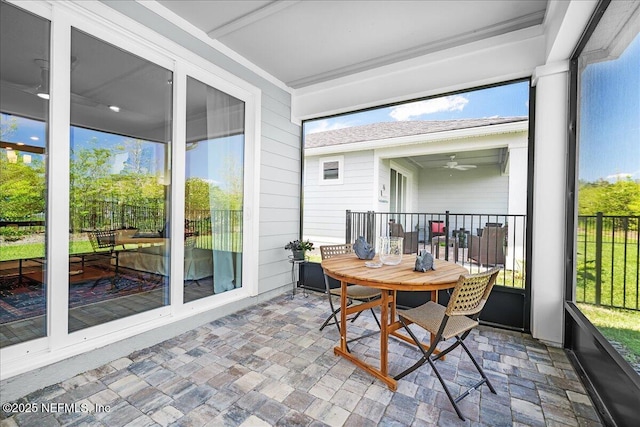 sunroom / solarium with a ceiling fan