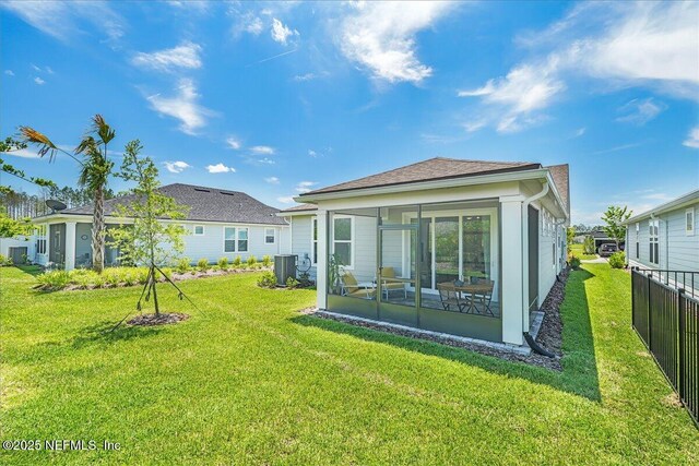 rear view of house with a sunroom and central air condition unit