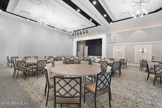 carpeted dining room with a chandelier, a high ceiling, and recessed lighting