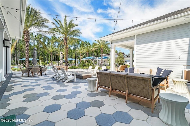 view of patio / terrace featuring an outdoor living space with a fire pit