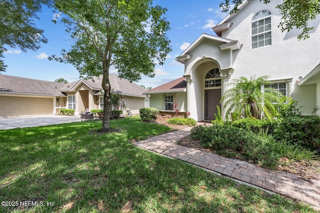 13759 Wingfield Pl, Jacksonville, FL 32224 - view of front of home with stucco siding, a front yard, and a garage