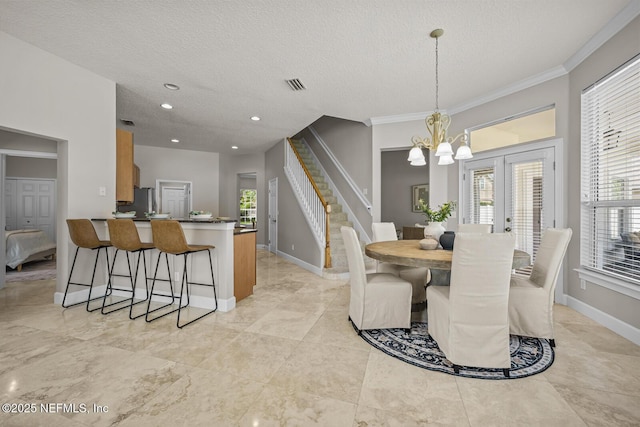 13759 Wingfield Pl, Jacksonville, FL 32224 - dining room with a chandelier, a textured ceiling, ornamental molding, healthy amount of natural light, and baseboards