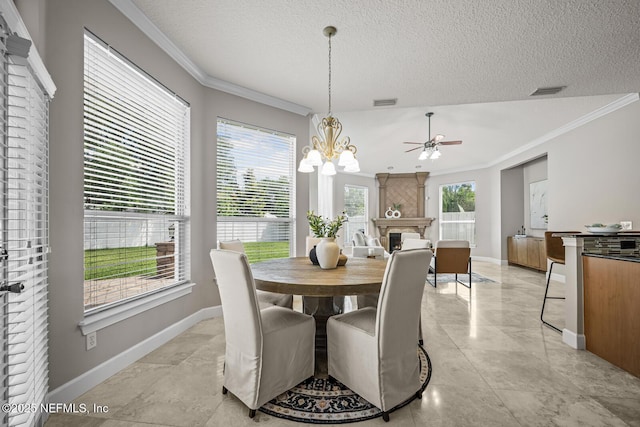 13759 Wingfield Pl, Jacksonville, FL 32224 - dining room with crown molding, a ceiling fan, baseboards, a fireplace, and a textured ceiling