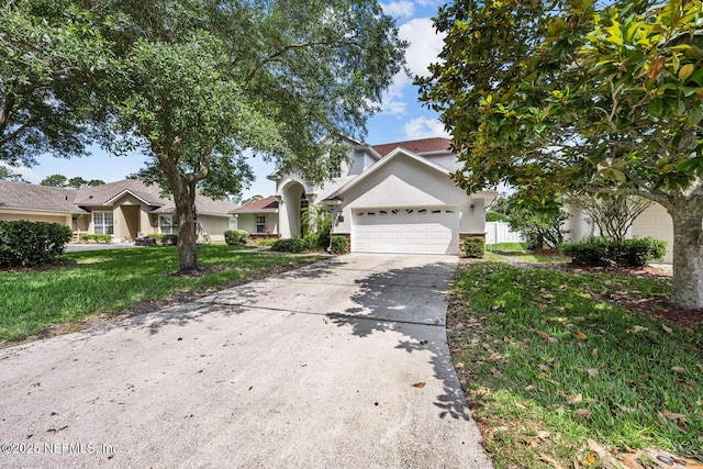 13759 Wingfield Pl, Jacksonville, FL 32224 - view of front of house with stucco siding, a garage, and driveway