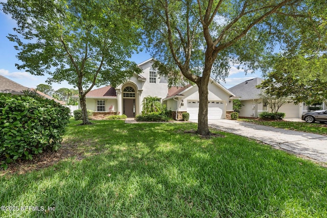 13759 Wingfield Pl, Jacksonville, FL 32224 - view of front of house with an attached garage, a front yard, stucco siding, and concrete driveway