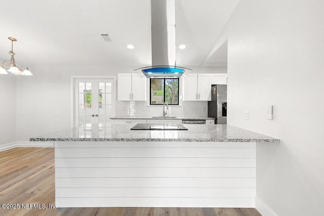 1169 Tumbleweed Dr, Orange Park, FL 32065 - kitchen featuring stainless steel fridge with ice dispenser, a sink, white cabinets, light stone countertops, and recessed lighting