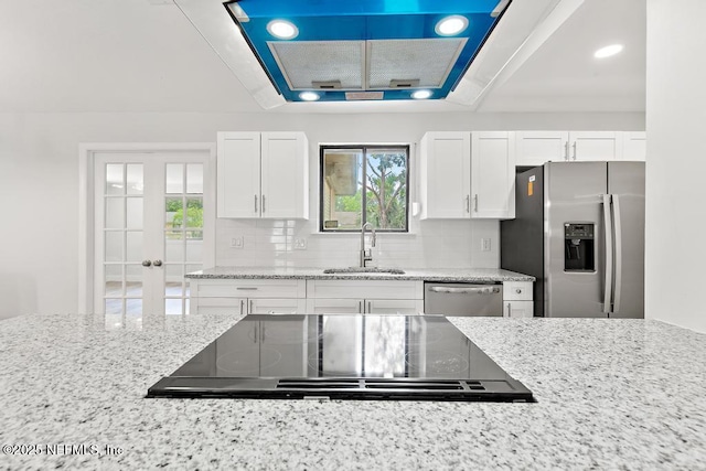 1169 Tumbleweed Dr, Orange Park, FL 32065 - kitchen with appliances with stainless steel finishes, a sink, french doors, light stone countertops, and white cabinets