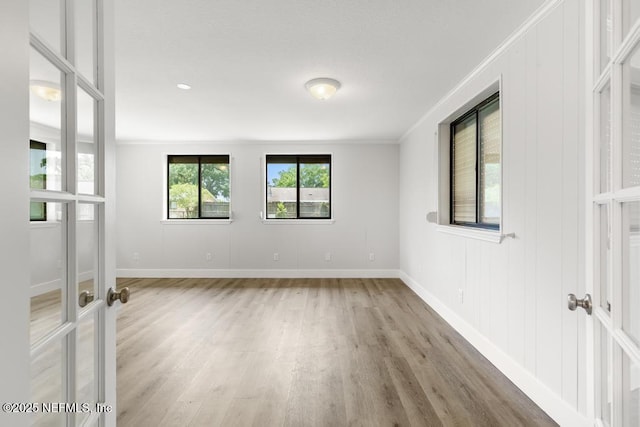 1169 Tumbleweed Dr, Orange Park, FL 32065 - unfurnished room with french doors, light wood-style flooring, baseboards, and crown molding