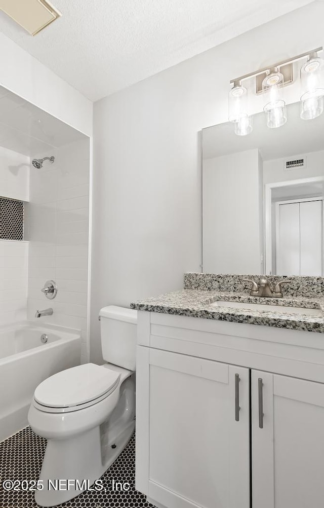 1169 Tumbleweed Dr, Orange Park, FL 32065 - full bathroom with toilet, vanity, tub / shower combination, and a textured ceiling