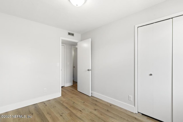 1169 Tumbleweed Dr, Orange Park, FL 32065 - unfurnished bedroom with baseboards, a closet, and light wood-style flooring
