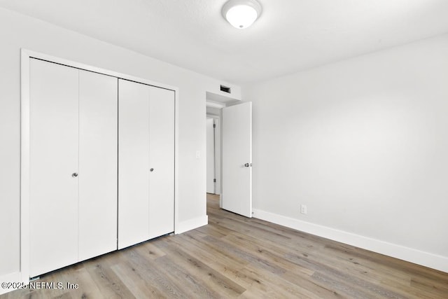 1169 Tumbleweed Dr, Orange Park, FL 32065 - unfurnished bedroom featuring baseboards, wood finished floors, and a closet