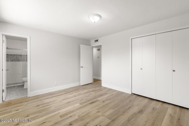1169 Tumbleweed Dr, Orange Park, FL 32065 - unfurnished bedroom featuring light wood finished floors, a closet, connected bathroom, and baseboards