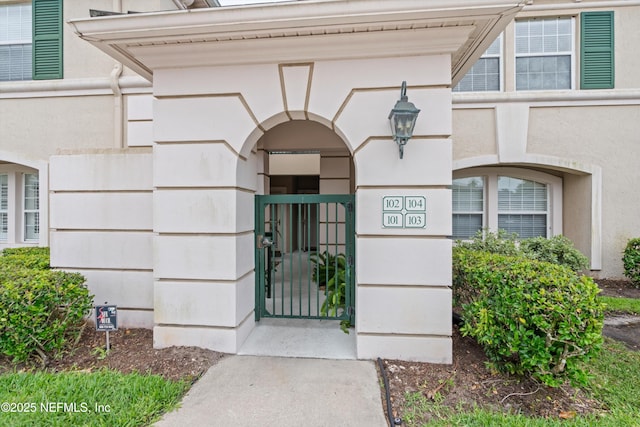 100 Bermuda Bay Cir Unit 104, Ponte Vedra Beach, FL 32082 - view of exterior entry featuring a gate and stucco siding