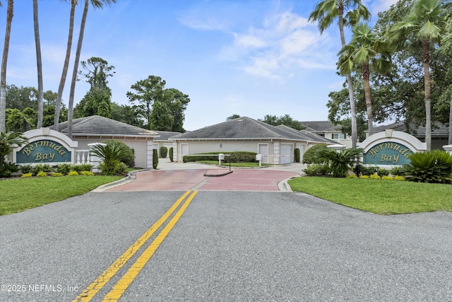 100 Bermuda Bay Cir Unit 104, Ponte Vedra Beach, FL 32082 - view of front of property with a front yard, gravel driveway, and stucco siding