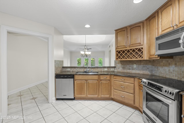 100 Bermuda Bay Cir Unit 104, Ponte Vedra Beach, FL 32082 - kitchen featuring stainless steel appliances, a sink, light tile patterned floors, decorative backsplash, and brown cabinetry