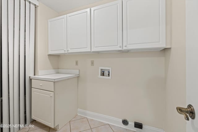 100 Bermuda Bay Cir Unit 104, Ponte Vedra Beach, FL 32082 - laundry area with washer hookup, cabinet space, baseboards, and light tile patterned floors