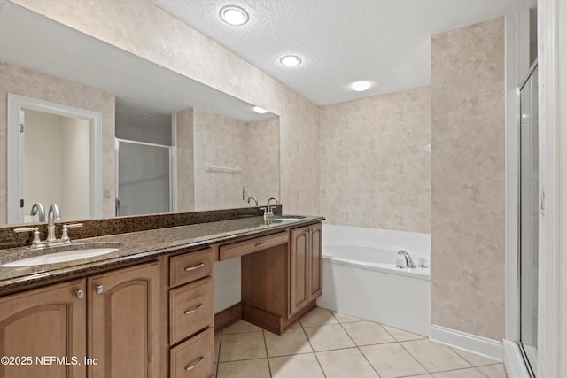 100 Bermuda Bay Cir Unit 104, Ponte Vedra Beach, FL 32082 - bathroom with double vanity, a stall shower, a garden tub, tile patterned flooring, and baseboards