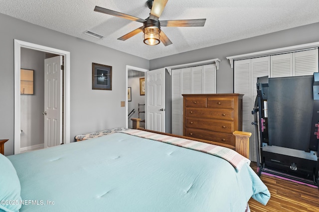 15 Ponte Vedra Ct Unit C, Ponte Vedra Beach, FL 32082 - bedroom with two closets, wood finished floors, a textured ceiling, and ceiling fan