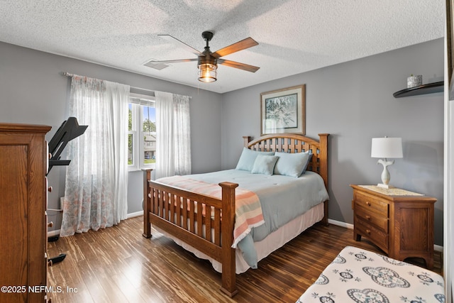 15 Ponte Vedra Ct Unit C, Ponte Vedra Beach, FL 32082 - bedroom with dark wood-style flooring, baseboards, a ceiling fan, and a textured ceiling
