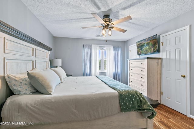 15 Ponte Vedra Ct Unit C, Ponte Vedra Beach, FL 32082 - bedroom with wood finished floors, a textured ceiling, and a ceiling fan