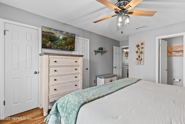 15 Ponte Vedra Ct Unit C, Ponte Vedra Beach, FL 32082 - bedroom featuring wood finished floors, a textured ceiling, and a ceiling fan