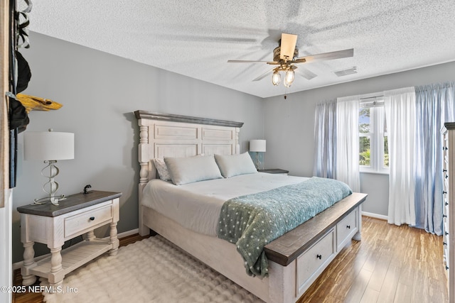 15 Ponte Vedra Ct Unit C, Ponte Vedra Beach, FL 32082 - bedroom with wood finished floors, a textured ceiling, a ceiling fan, and baseboards