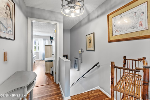 15 Ponte Vedra Ct Unit C, Ponte Vedra Beach, FL 32082 - hallway with an upstairs landing, wood finished floors, a textured ceiling, and baseboards