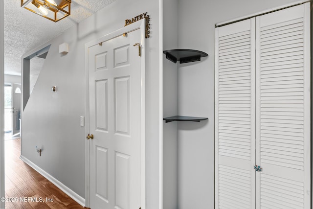 15 Ponte Vedra Ct Unit C, Ponte Vedra Beach, FL 32082 - hall with a textured ceiling, baseboards, and dark wood-type flooring