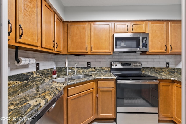 15 Ponte Vedra Ct Unit C, Ponte Vedra Beach, FL 32082 - kitchen with appliances with stainless steel finishes, a sink, tasteful backsplash, and brown cabinetry