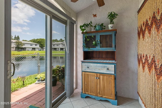 15 Ponte Vedra Ct Unit C, Ponte Vedra Beach, FL 32082 - doorway to outside with a textured wall, a ceiling fan, vaulted ceiling, and light tile patterned floors