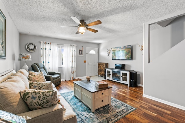 15 Ponte Vedra Ct Unit C, Ponte Vedra Beach, FL 32082 - living room featuring a ceiling fan, dark wood-style flooring, baseboards, and a textured ceiling