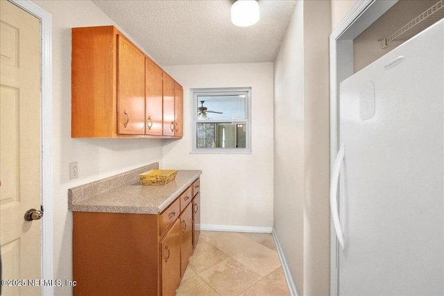 905 Ridgeway Ct, Orange Park, FL 32065 - washroom with a textured ceiling, baseboards, a ceiling fan, and light tile patterned flooring