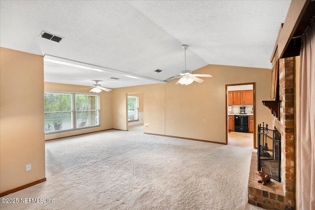 905 Ridgeway Ct, Orange Park, FL 32065 - unfurnished living room featuring ceiling fan, a brick fireplace, light carpet, baseboards, and a textured ceiling