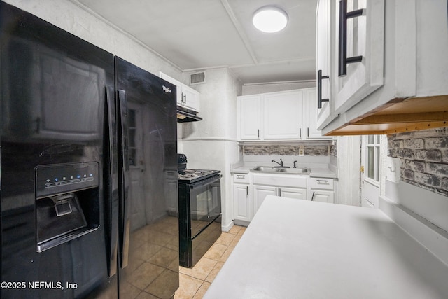 4357 Trenton Dr S, Jacksonville, FL 32209 - kitchen with black appliances, a sink, white cabinetry, light tile patterned flooring, and under cabinet range hood