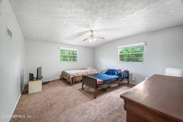 4357 Trenton Dr S, Jacksonville, FL 32209 - carpeted bedroom with a ceiling fan, a textured ceiling, and baseboards