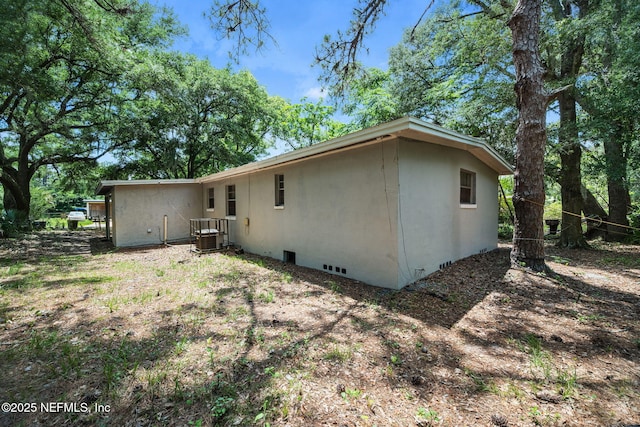 4357 Trenton Dr S, Jacksonville, FL 32209 - rear view of property featuring stucco siding, crawl space, and central AC