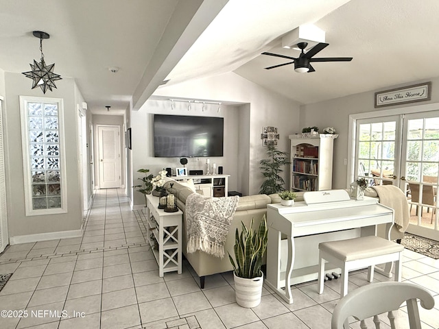 12753 Burning Tree Ln W, Jacksonville, FL 32223 - living room with ceiling fan, light tile patterned flooring, vaulted ceiling, and baseboards