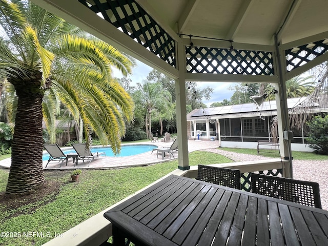 12753 Burning Tree Ln W, Jacksonville, FL 32223 - deck featuring a sunroom, a patio area, outdoor dining area, and an outdoor pool