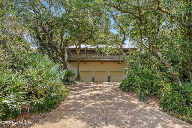1927 Beachside Ct, Atlantic Beach, FL 32233 - obstructed view of property with concrete driveway, an attached garage, stucco siding, and a balcony
