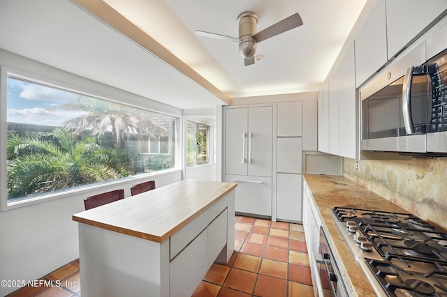 1927 Beachside Ct, Atlantic Beach, FL 32233 - kitchen featuring stainless steel appliances, a ceiling fan, white cabinets, and wood counters